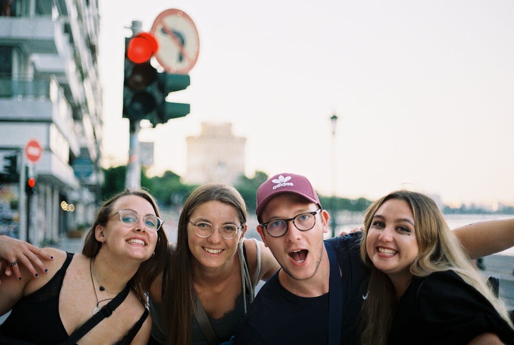 Group of young friends smiling and enjoying a day out in the city center.